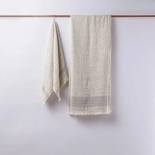 Textured off-white linen towels hanging on copper rod, perfect as double-layered muslin bath towels in Cotton Nope Yarn