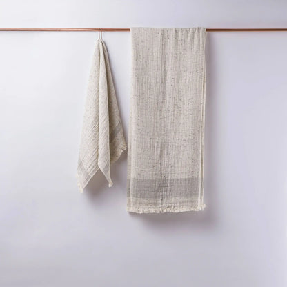 Textured off-white linen towels hanging on copper rod, perfect as double-layered muslin bath towels in Cotton Nope Yarn