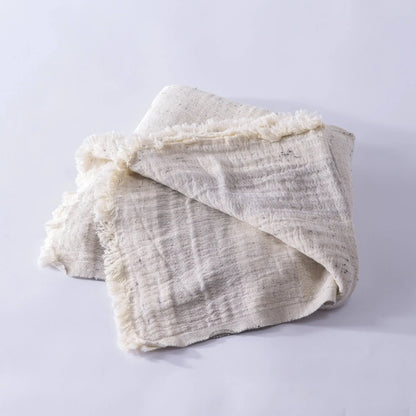 Off-white cotton nope yarn muslin bath towel with dark speckles and frayed edges