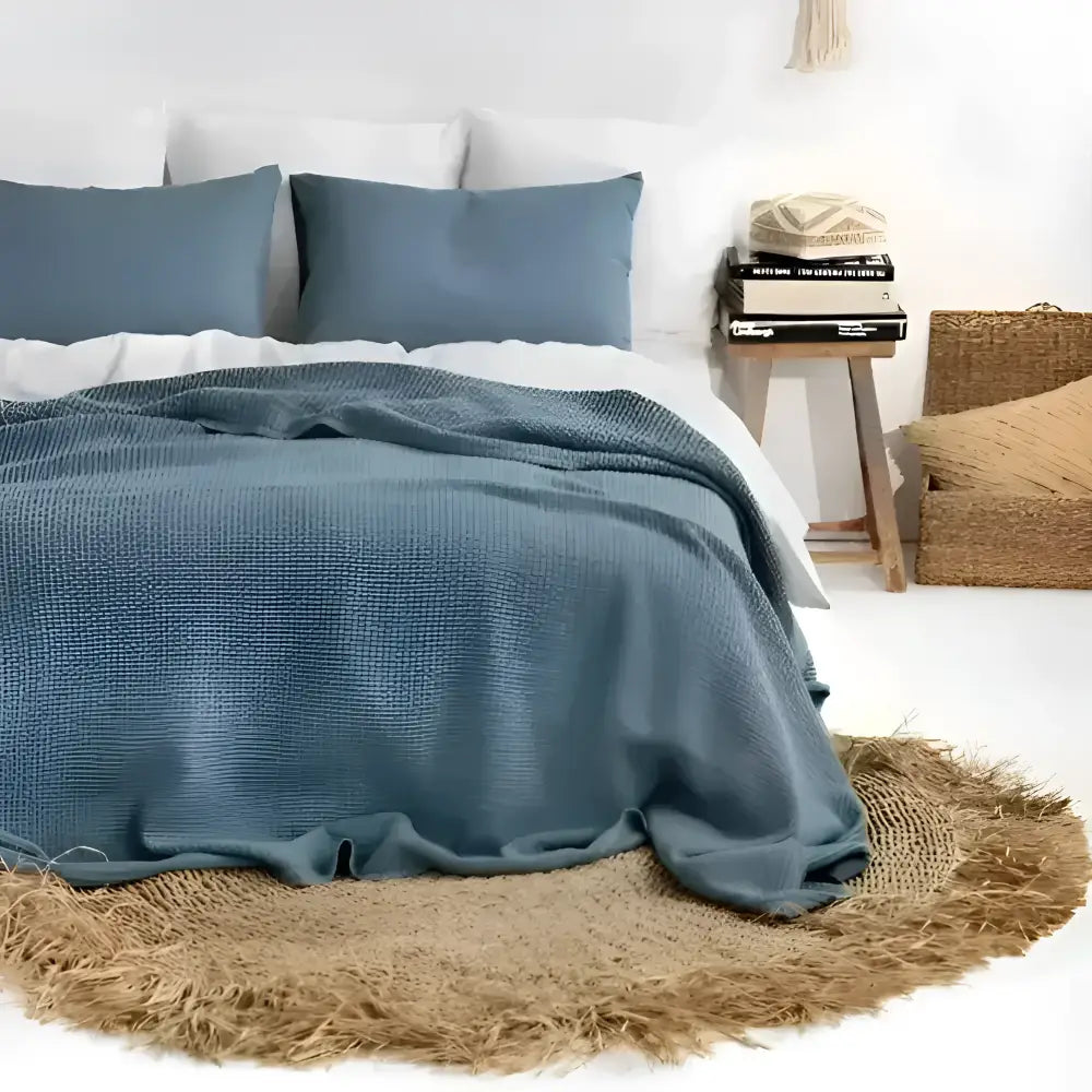 Linen waffle blanket in blue on a bed