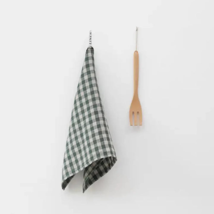Forest Green Gingham Linen Kitchen Towel hanging next to a wooden utensil