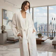 Woman in white bathrobe with pockets, everyday linen robe in fine stripes European linen