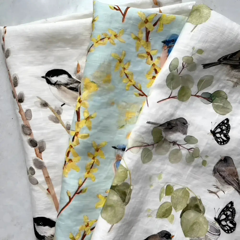 Set of three towels with nature-themed patterns on a light background