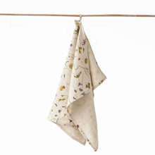 100% Linen tea towel with a natural base color and embellished with botanical prints inspired by pressed flowers. 