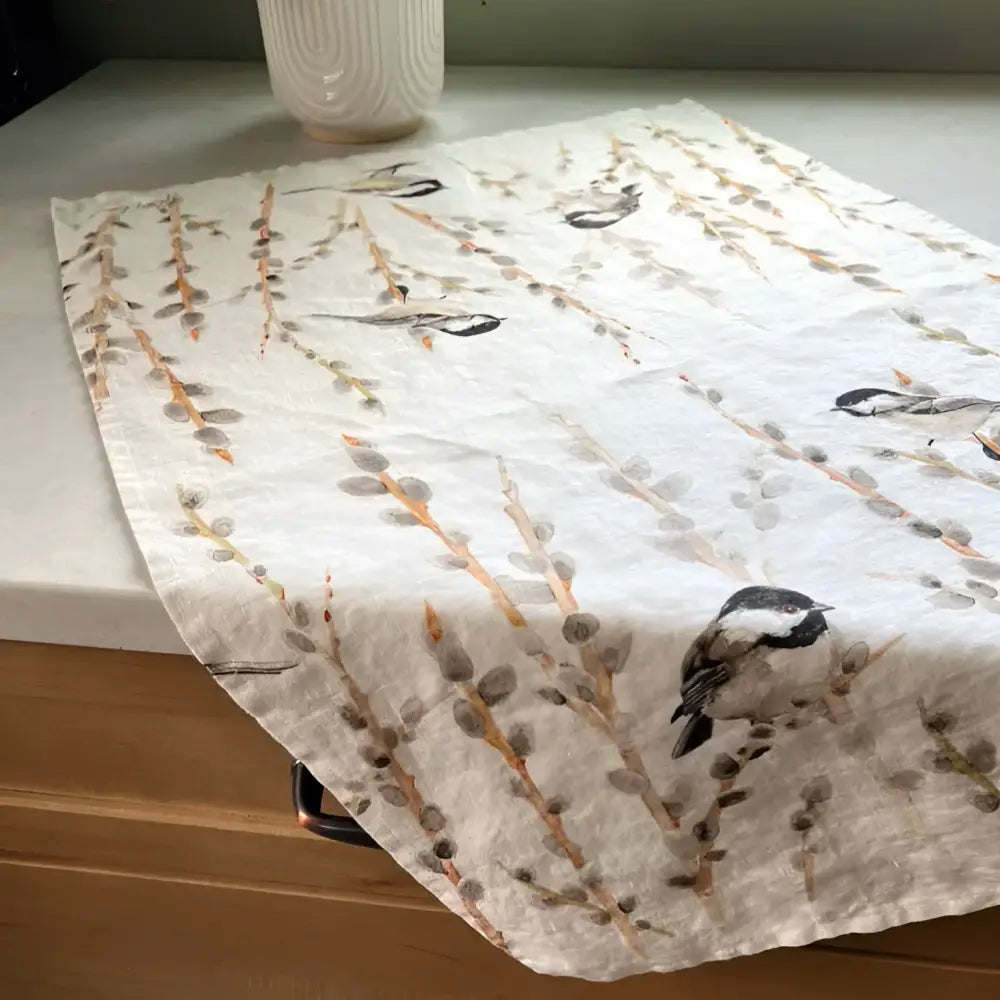 Towel with bird and branch pattern on a kitchen counter