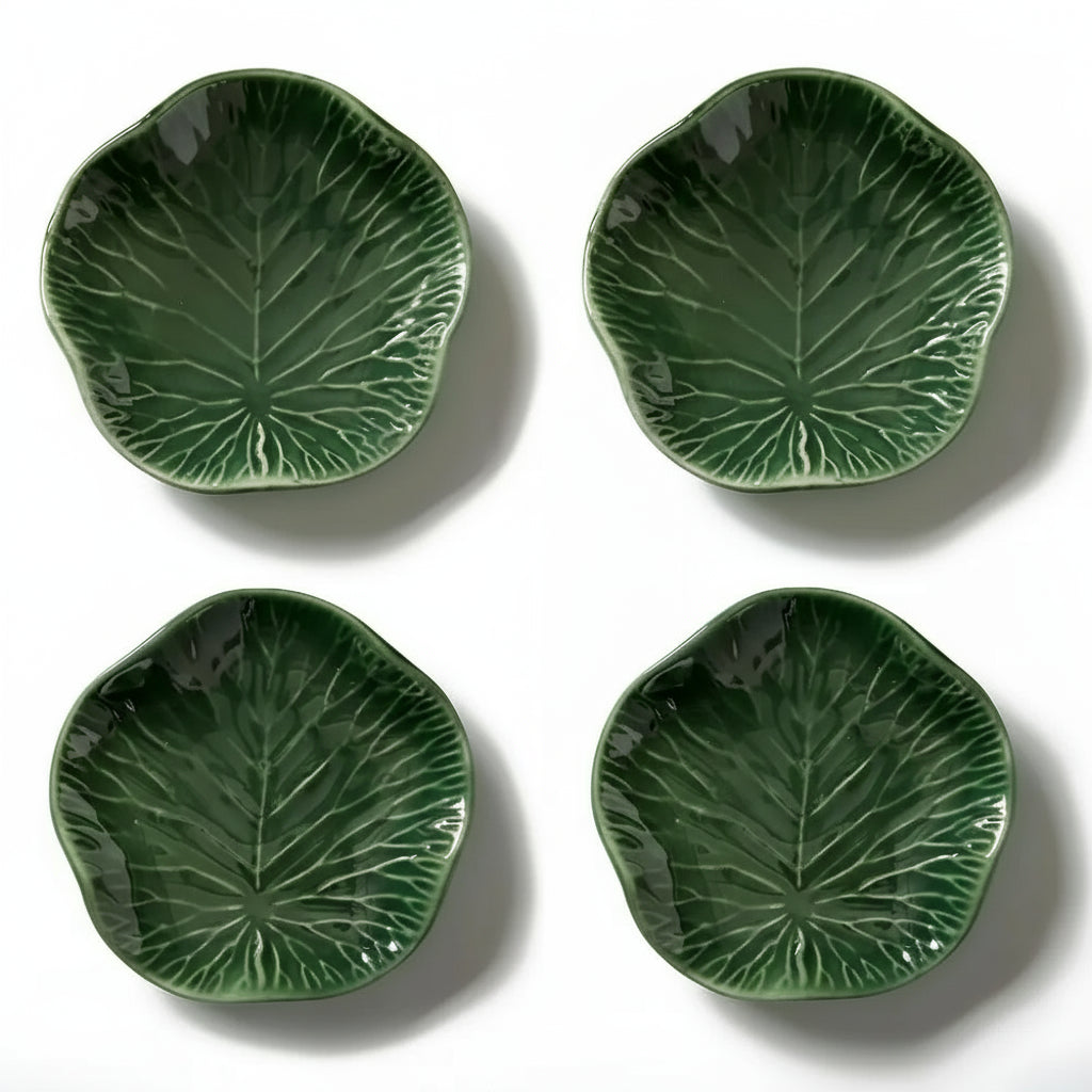 Green lotus leaf-shaped ceramic salad plates with embossed veins and glossy finish