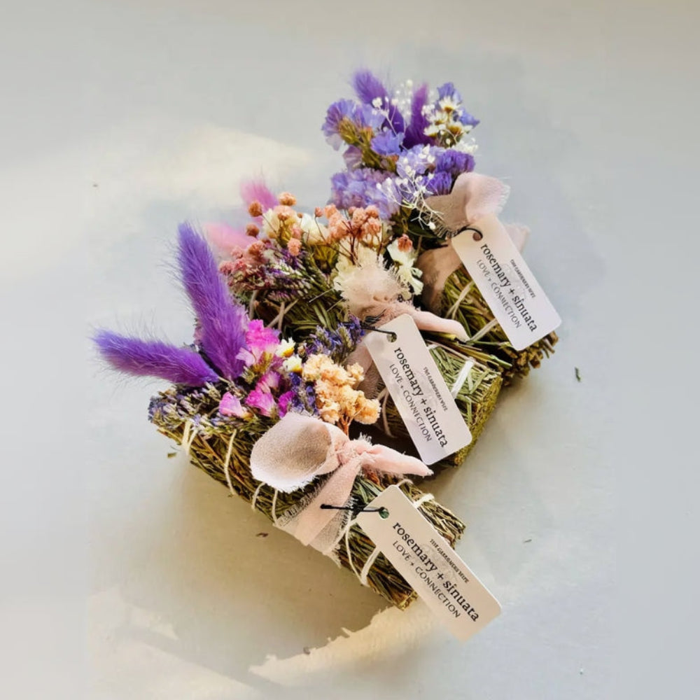 Handmade eco-friendly woven basket with dried purple pink white flowers tied in pale pink ribbons from Love + Connection Bundle