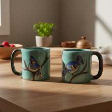 Handcrafted Mara Stoneware Blue Jay Mug with teal ceramic and black handles