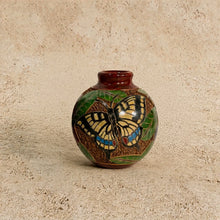 Mini carved clay vase with glossy brown glaze featuring intricate hand carvings of a yellow butterfly and green leaves