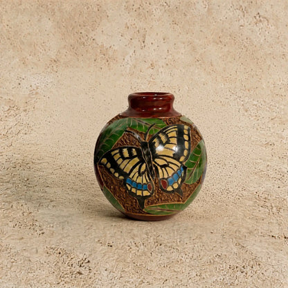 Mini carved clay vase with glossy brown glaze featuring intricate hand carvings of a yellow butterfly and green leaves