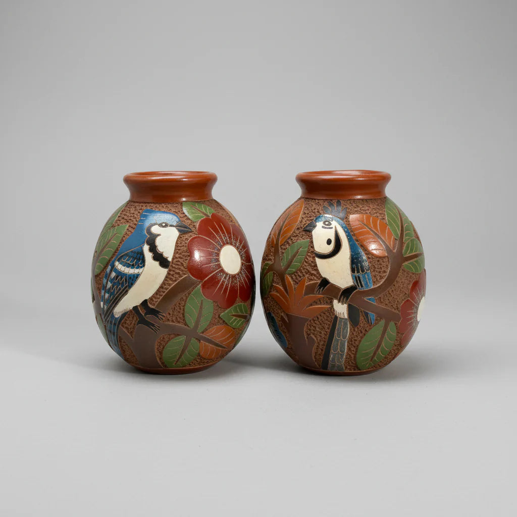 Mini carved clay vases with intricate hand carvings and blue jay floral designs