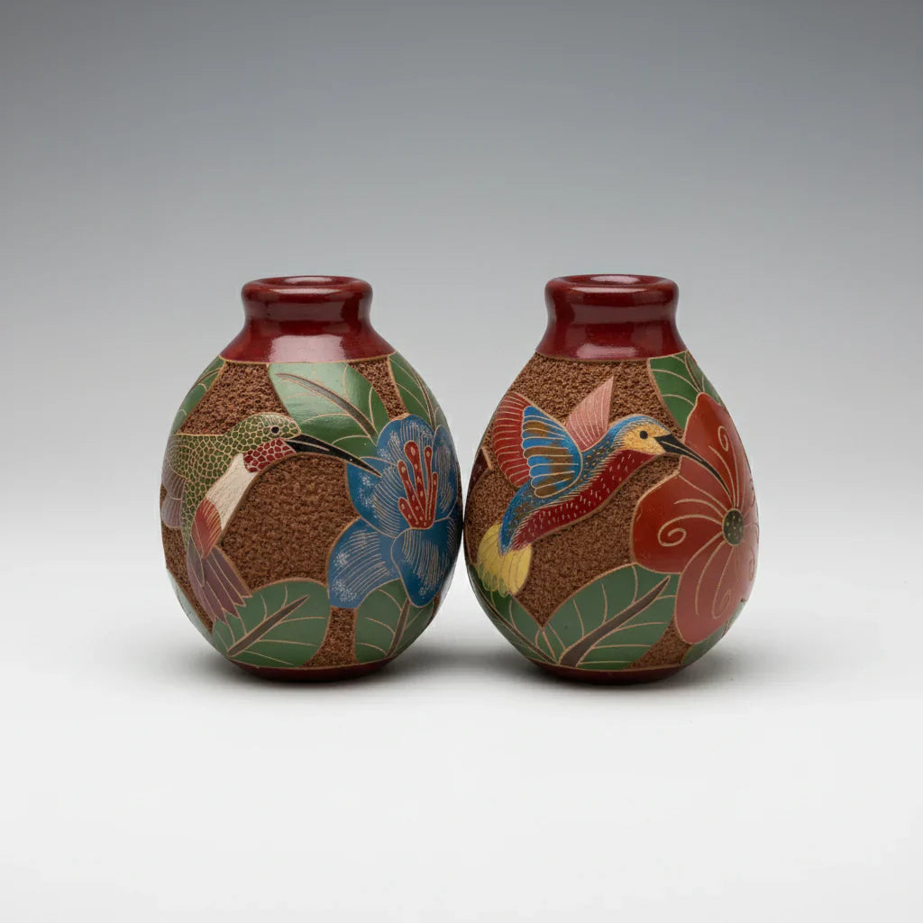 Mini carved clay vases with intricate hand carvings and colorful hummingbird designs