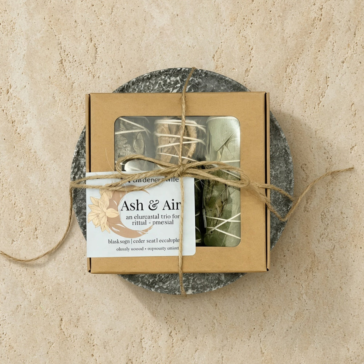 A beige cardboard mini smudge nest tied with twine containing sage trio and a soapstone plate discover rookery nests