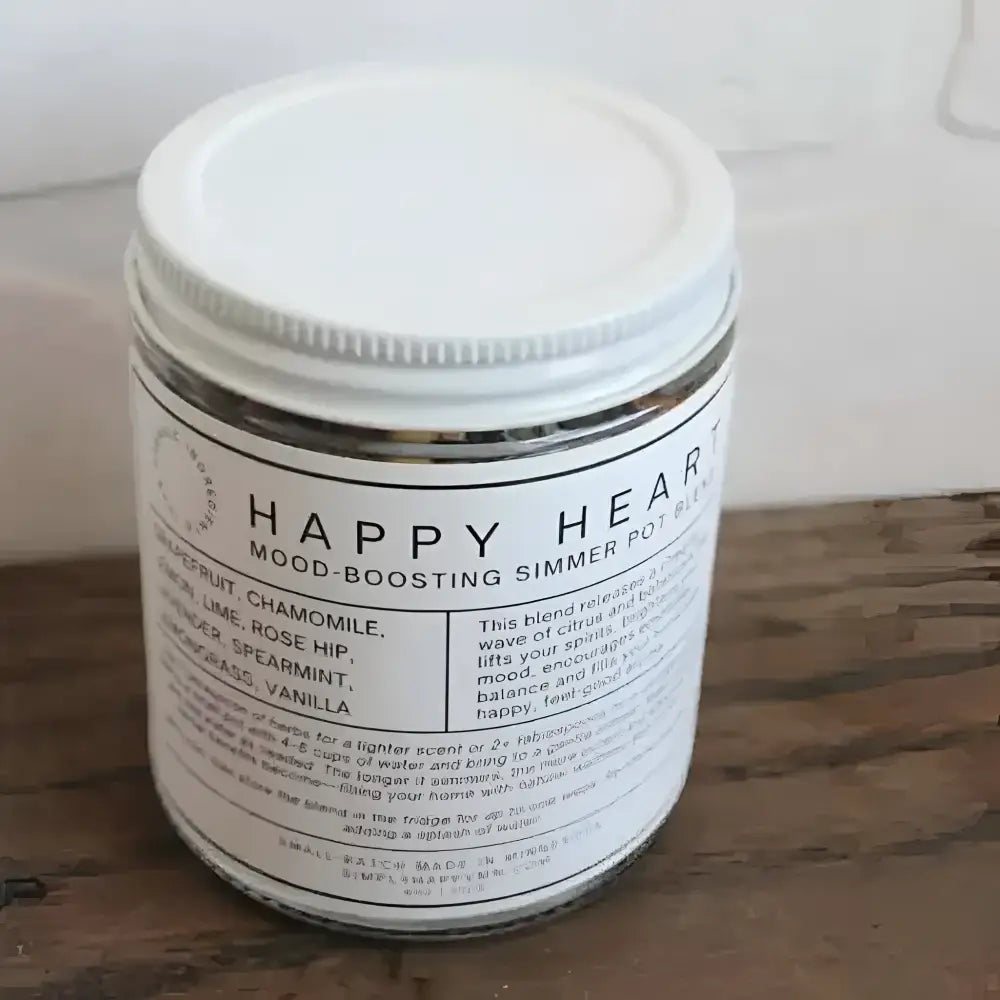 A white-labeled glass jar with a silver lid containing happy heart mood-boosting simmer pot blend