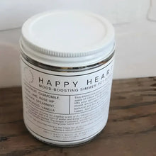 A white-labeled glass jar with a silver lid containing happy heart mood-boosting simmer pot blend