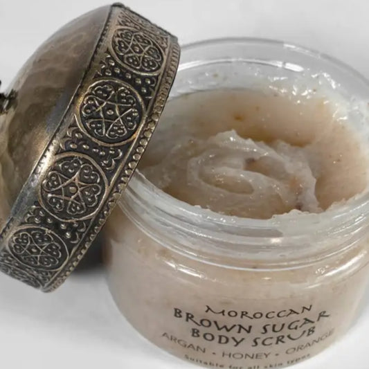 Open jar of Moroccan brown sugar body scrub with argan honey and orange for silky skin