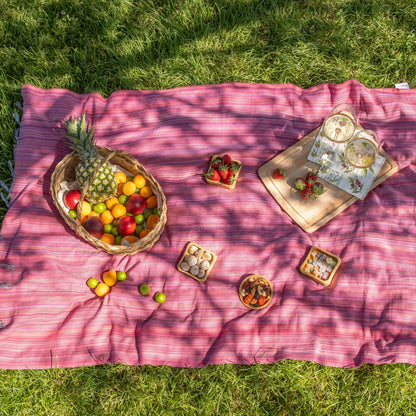 Pink striped Turkish beach towel with fringe, perfect for a colorful sand free beach vibe