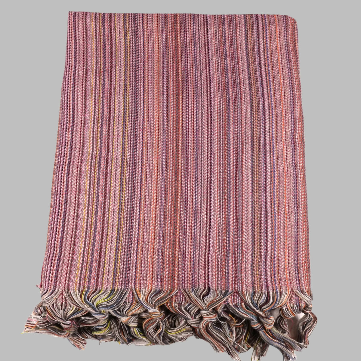 Colorful Turkish beach towel with pink, purple, orange stripes and tassels for sand-free fun