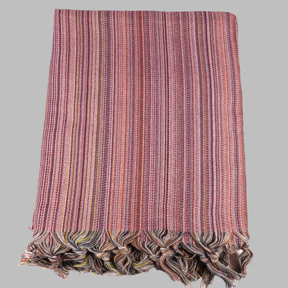 Colorful Turkish beach towel with pink, purple, orange stripes and tassels for sand-free fun
