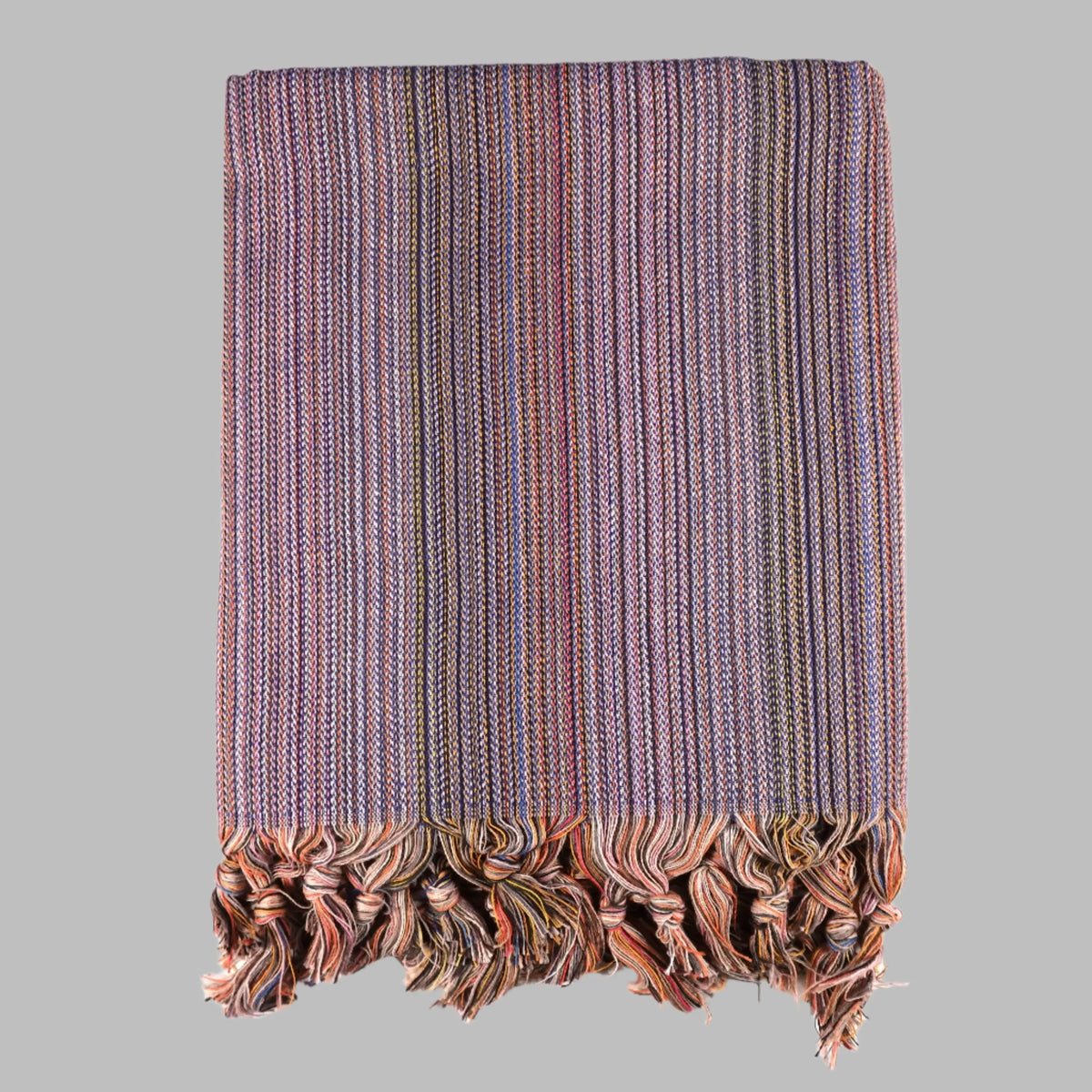 Colorful Turkish beach towel with striped pattern and knotted fringe for sandy days