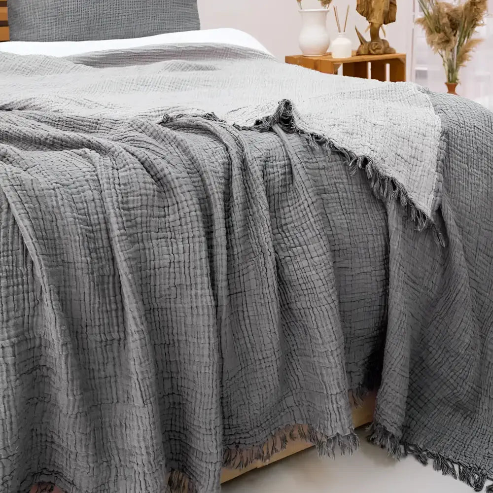 Bedroom with gray bedding and decorative hats on the wall