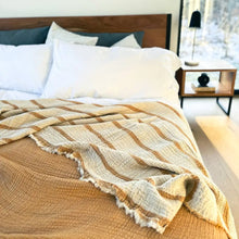 Mustard and cream colored reversible striped muslin blanket for king or queen sized beds.