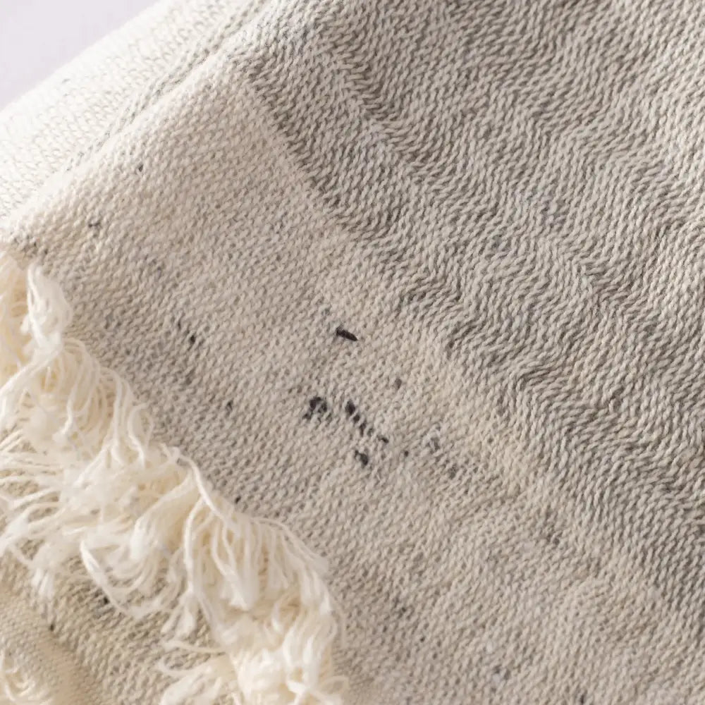 A close up of a beige muslin towel.