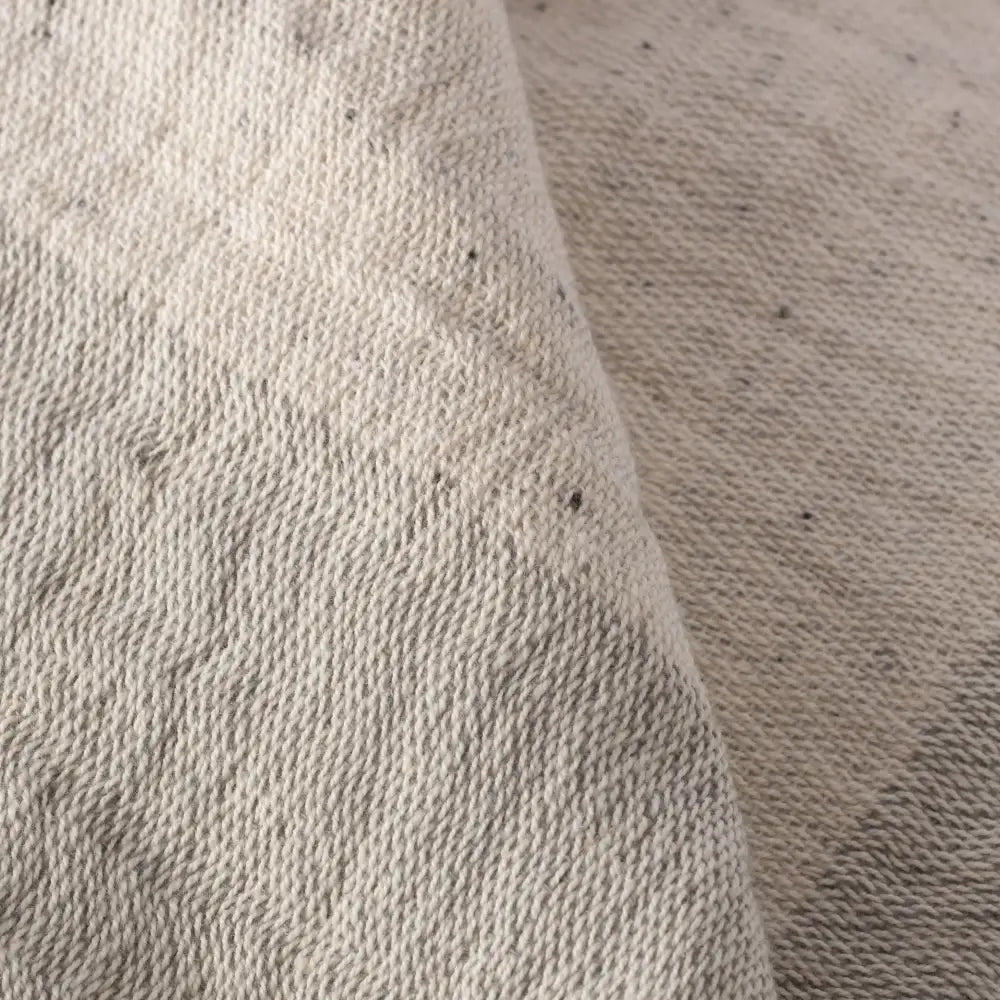 Close up of beige muslin towel in nope yarn.