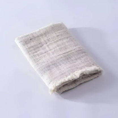 Folded textured towel on a light gray background