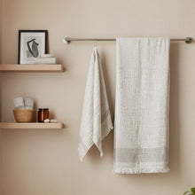 Two off-white textured cotton towels, one hanging, one flat, Muslin Turkish Hand Towel