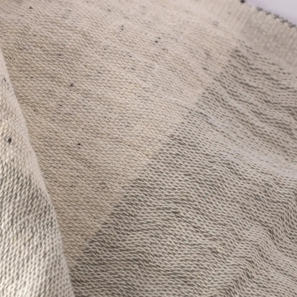 Light gray double-sided muslin hand towel with eyelash fringe ends. 