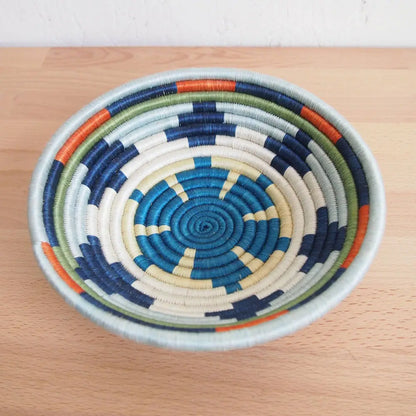 Handmade mwangaza small bowl with concentric blue white navy green and orange rings, eco-friendly and handcrafted design