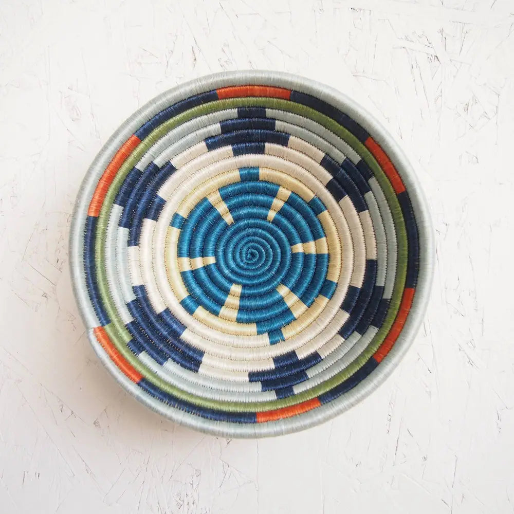 Handmade mwangaza small bowl with eco-friendly blue white navy green and orange fibers in a spiral pattern