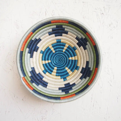 Handmade mwangaza small bowl with eco-friendly blue white navy green and orange fibers in a spiral pattern