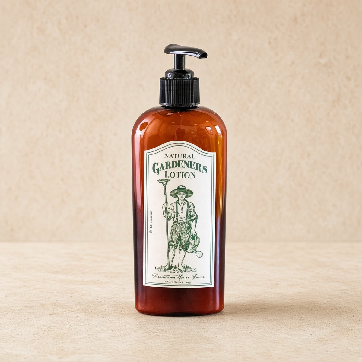 Amber glass bottle of handmade eco-friendly gardener’s lotion with black pump and vintage gardener label