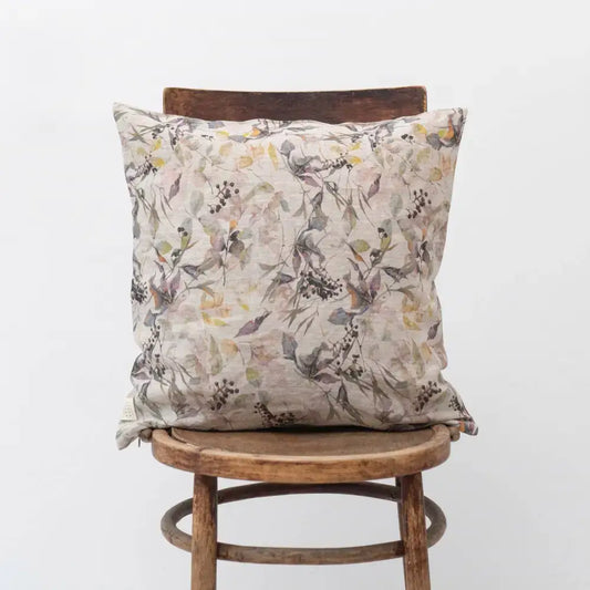 Pillow with floral design on wooden chair