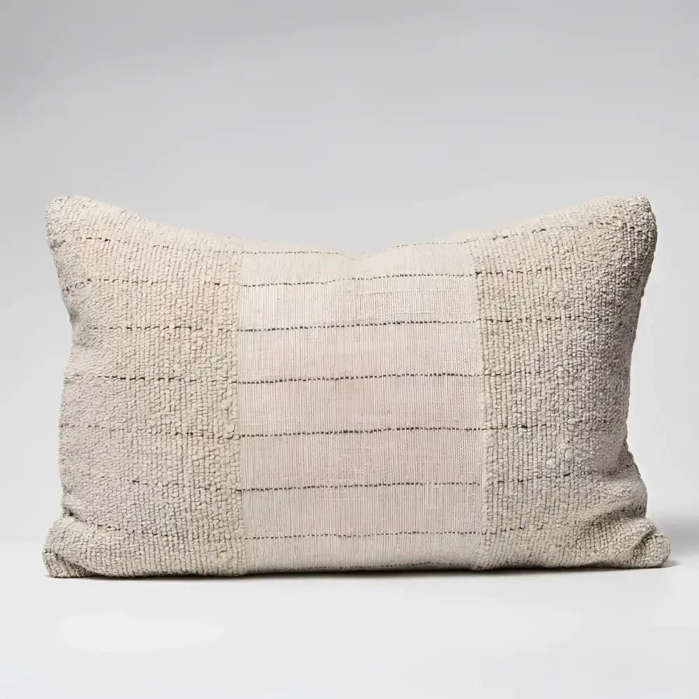 Textured pillow in natural color with black stripes.