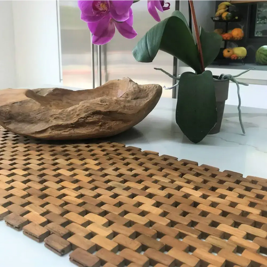 Woven wooden table runner from recycled teak pieces for a natural teak table setting