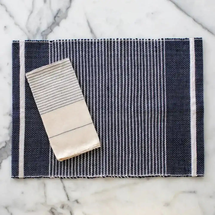 Adwa Recycled Cotton Placemat in Navy on a marble surface