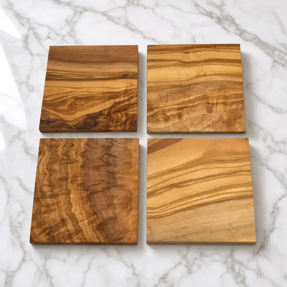 Set of four square coasters handcrafted from olive wood with unique golden and brown natural grain patterns