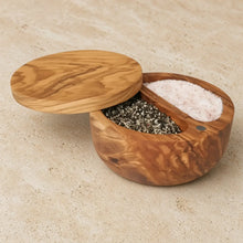 Handcrafted olive wood dual compartment spice cellar with warm finish and swiveling magnetic lid for salt and pepper