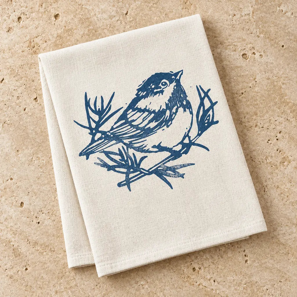 Beige organic cotton chickadee kitchen towel with navy original chickadee design on branches for everyday use