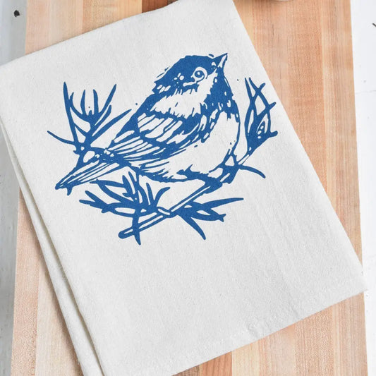  A white cloth napkin, hand-printed with an original Chickadee design in navy blue. 
