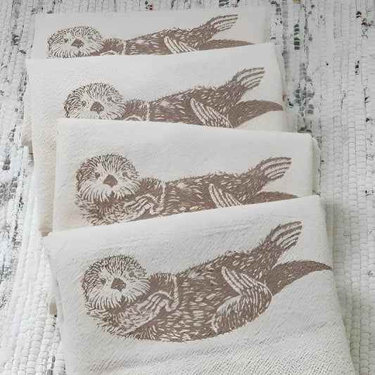 Four cotton napkins with otter design.
