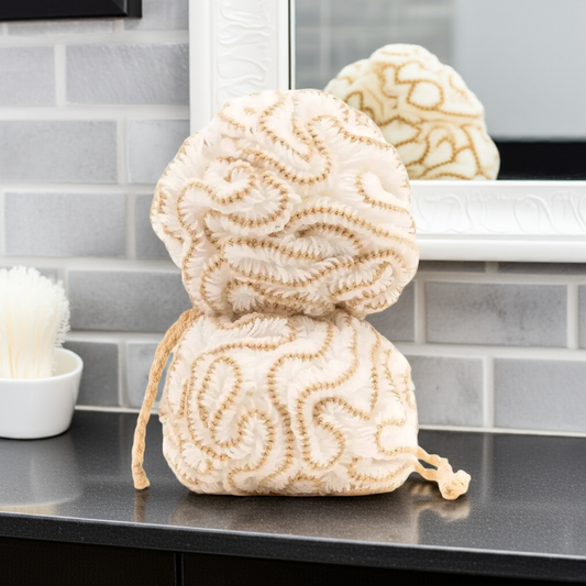 Three beige and white textured scrubbing balls on a kitchen counter.