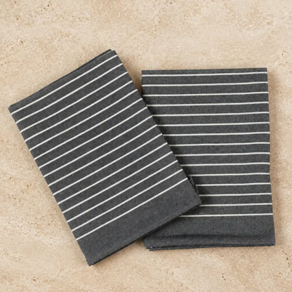 Dark gray linen napkins with thin white stripes included in organic cotton tea towel set with wearable kitchen towels