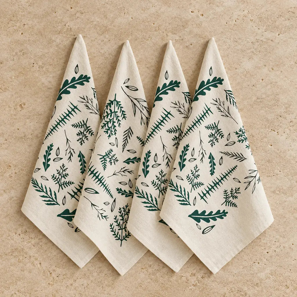 Set of four cream-colored organic cotton woodland fern napkins with dark green and black original woodland ferns print