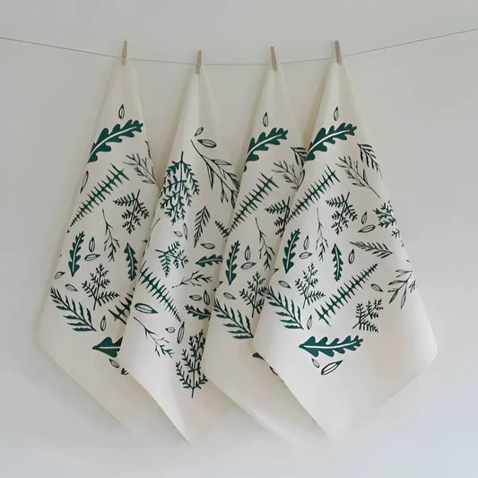 A set of four organic cloth napkins, hand-printed with an original Woodland Ferns design in green. 