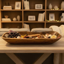 Decorative wooden bowl filled with potpourri made from salvaged teak root