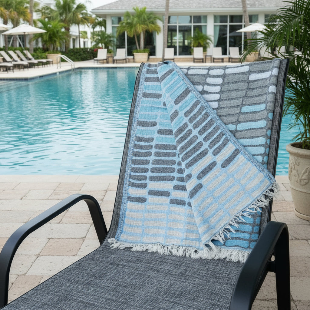 Blue and gray patterned Turkish towel with white fringes, quick drying and sand resistant